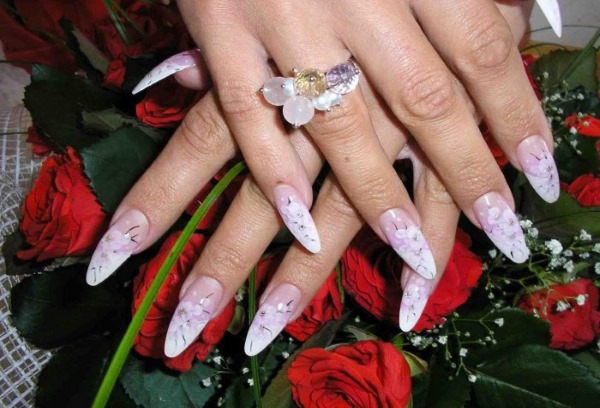 Ongles en forme d'amande.Tendances de la mode dans le design 2020, photo: pâle, français, nu, ombre, avec des étincelles, des strass, des frottements